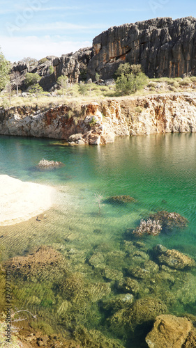 Pond lake situated in lush landscape at Boab Quarry Campsite in Western Australia.