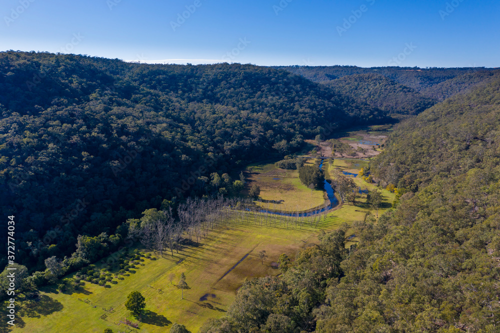 A fresh water creek running through a green lush valley in regional New South Wales in Australia A fresh water creek running through a green lush valley in regional New South Wales in Australia