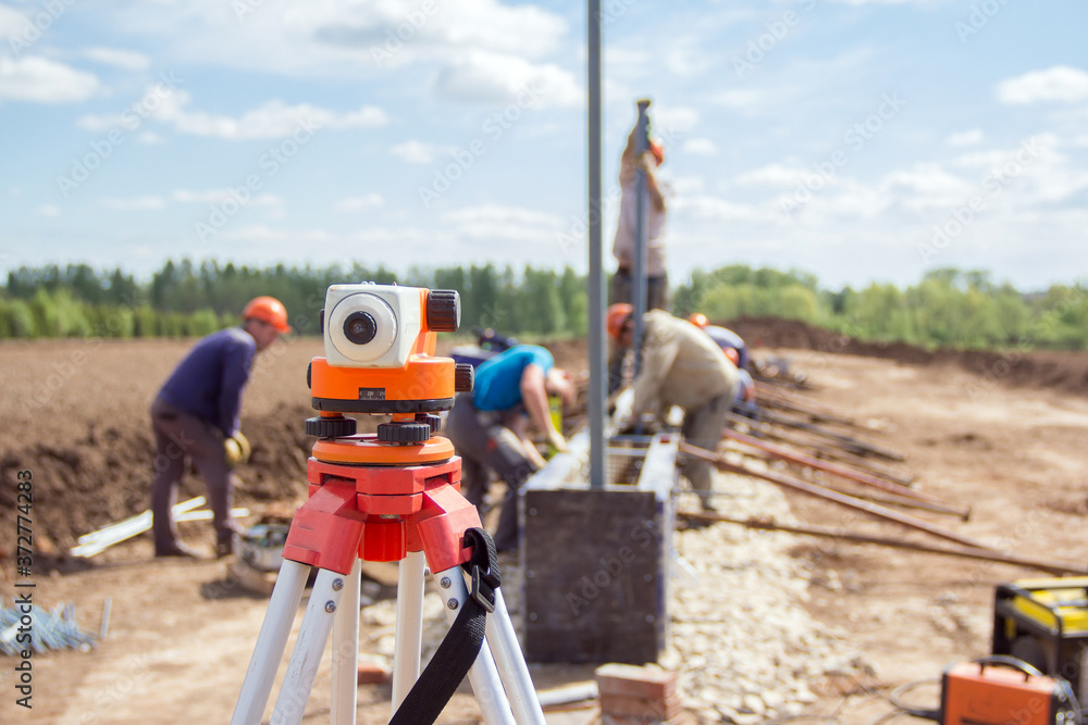Construction equipment. Surveyors equipment theodolite on the construction site. Monitoring the progress of construction work. Construction equipment. Surveyors equipment theodolite on the construction site. Monitoring the progress of construction work.