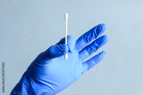 A cotton swab in the hands of a medic