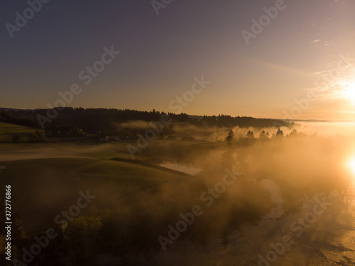 Sunrise or sunset on the lake with fog and steam