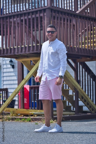 young man in front of a house