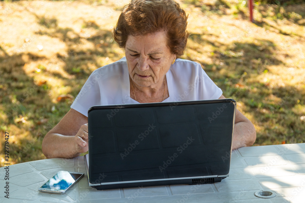 senior woman working or learning with laptop senior woman working or learning with laptop