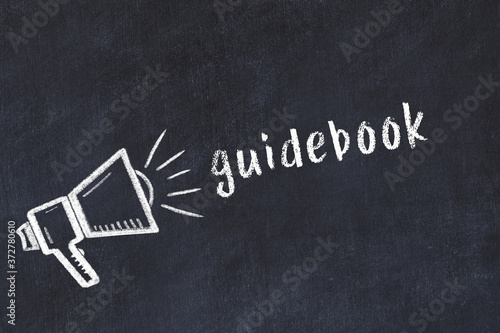 Φωτογραφία Chalk loudspeaker and inscription guidebook on black chalkboard