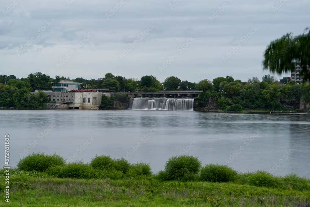 Obraz premium A waterfalls falling into a river
