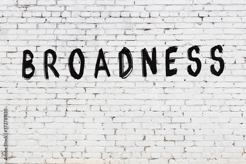 Inscription broadness painted on white brick wall