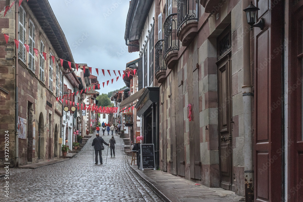Fototapeta premium City of pilgrimage Saint-Jean-Pied-de-Port in the Antlantic Pyrenees. Station on the Way of St. Jacob. The Pilgrim's Way. Tourist location. Popular cities in France. Europe's narrow cobbled street.