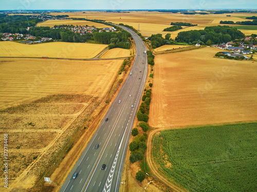 Aerial drone view of beautiful French countryside and six-lane motorway