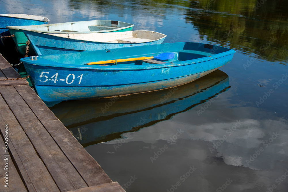 Wooden fishing rowing boats on the river . Wooden fishing rowing boats on the river .