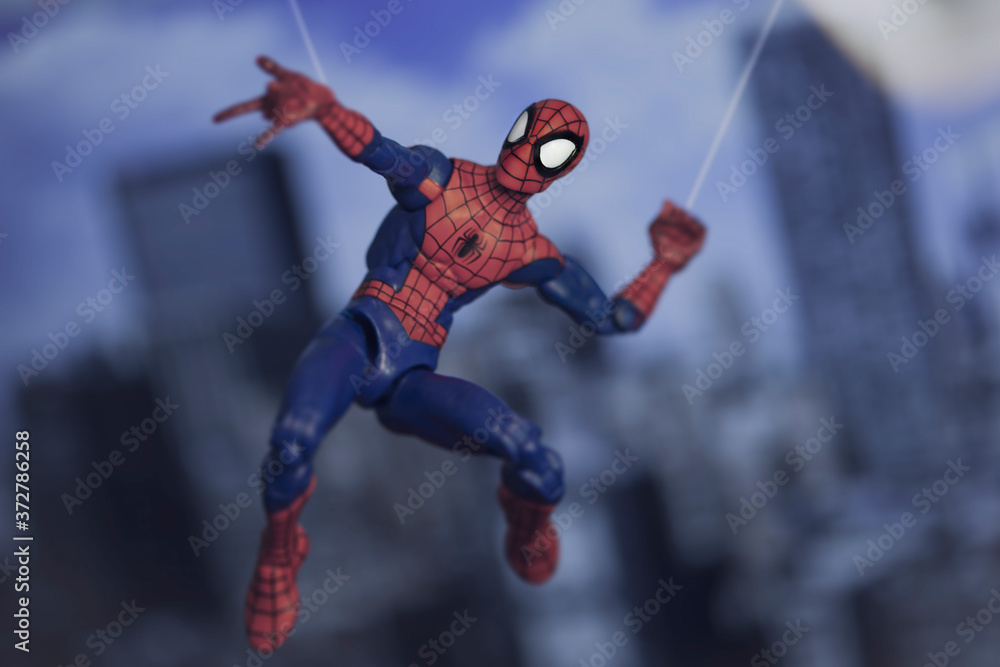 Obraz premium NEW YORK USA, AUGUST 21 2020: Spiderman from Marvel Comics and The Avengers swinging from a web - Hasbro action figure