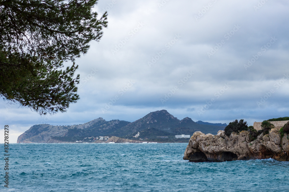 The coast of Mallorca in Cala Ratjada. Mediterranean sea, rocks and mountain. The coast of Mallorca in Cala Ratjada. Mediterranean sea, rocks and mountain.