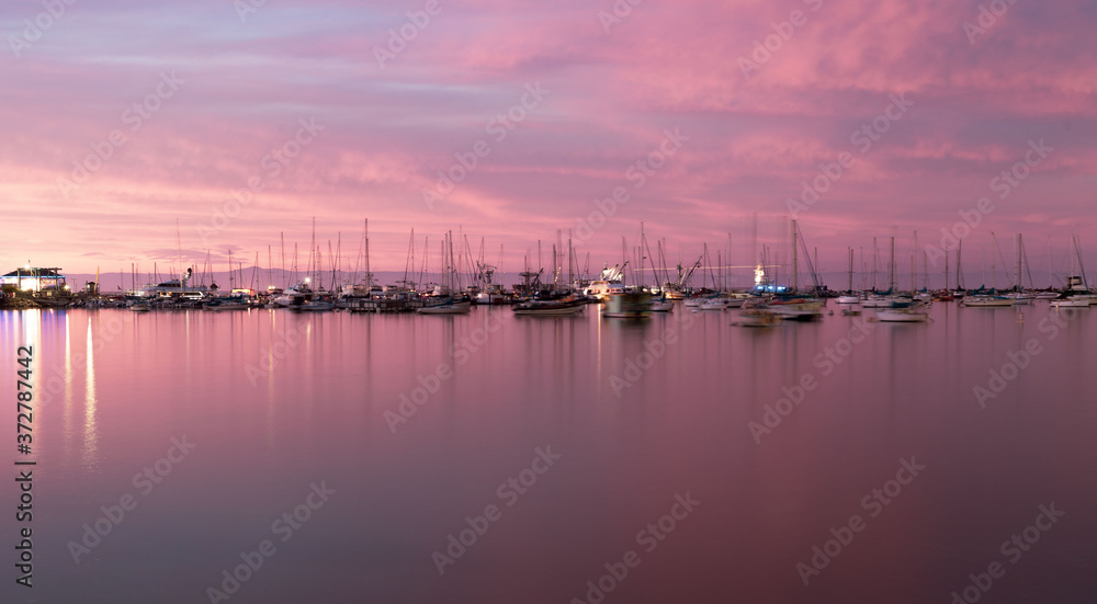 pink summer sunset of  sailboats on the pier