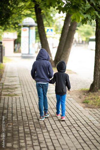 children walk around the city, family walk on the street, children walk on the day off
