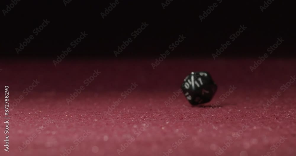 Close-up of Black 20-Sided Dice Rolling in Slow Motion Revealing 2 Side Close-up of Black 20-Sided Dice Rolling in Slow Motion Revealing 2 Side