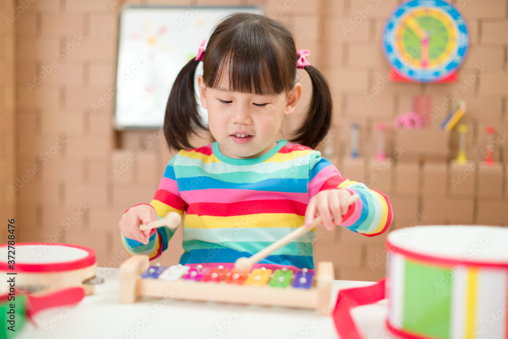 young girl play xylophone at home for homeschooling young girl play xylophone at home for homeschooling
