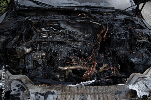 Burnt destroyed car engine after fire.