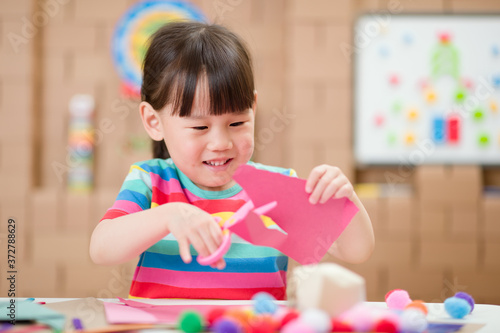 toddler girl  making craft for homeschooling