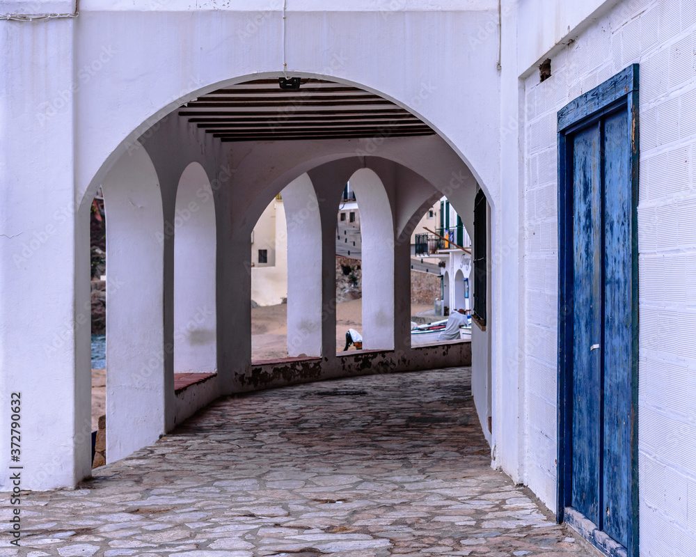 Passage with arches at the coastline town of Calella de Palafrugell (Catalonia, Spain)