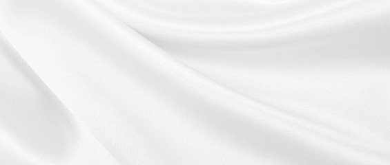 Smooth elegant white silk or satin luxury cloth texture as wedding background. Luxurious background design