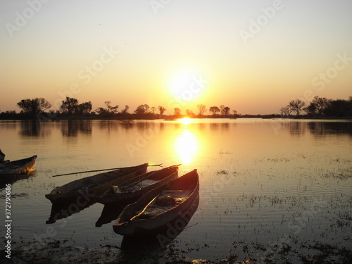 sunset with mocoro boat in the Okavango Delta