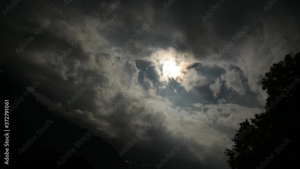 Time lapse of Moon Rolling Over Beautiful Clouds in Swiss Alps Time lapse of Moon Rolling Over Beautiful Clouds in Swiss Alps