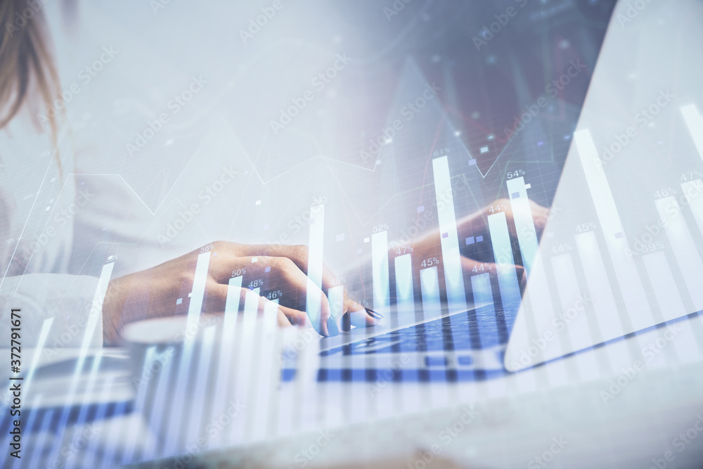 Double exposure of woman hands working on computer and forex graph hologram drawing. Financial analysis concept. Double exposure of woman hands working on computer and forex graph hologram drawing. Financial analysis concept.