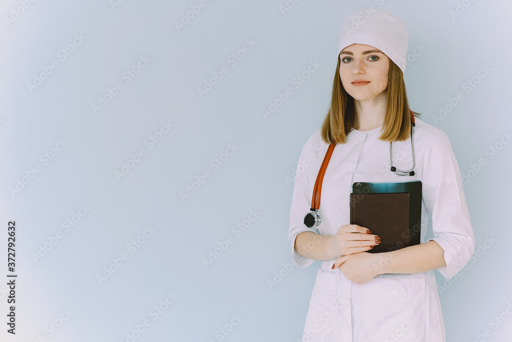 Smiling medical doctor woman with stethoscope. Isolated over white background. Image of an enthusiastic intern looking at camera Smiling medical doctor woman with stethoscope. Isolated over white background. Image of an enthusiastic intern looking at camera