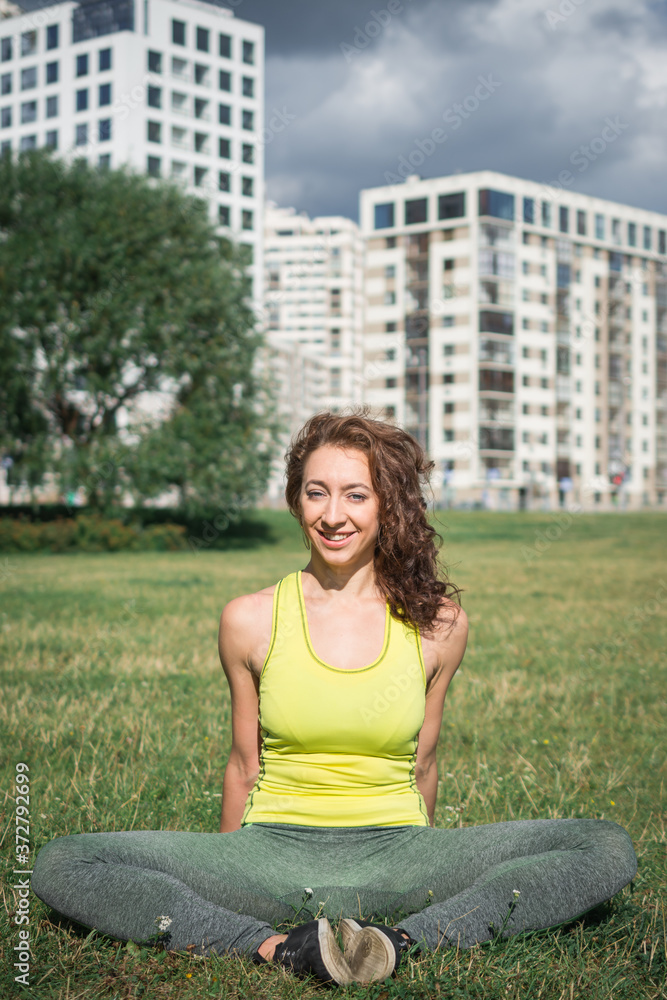 Young woman stretching body after jogging outdoor Young woman stretching body after jogging outdoor