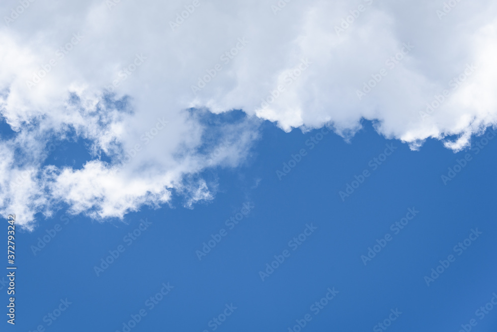 Cumulus cloud against a blue sky on a clear sunny day
