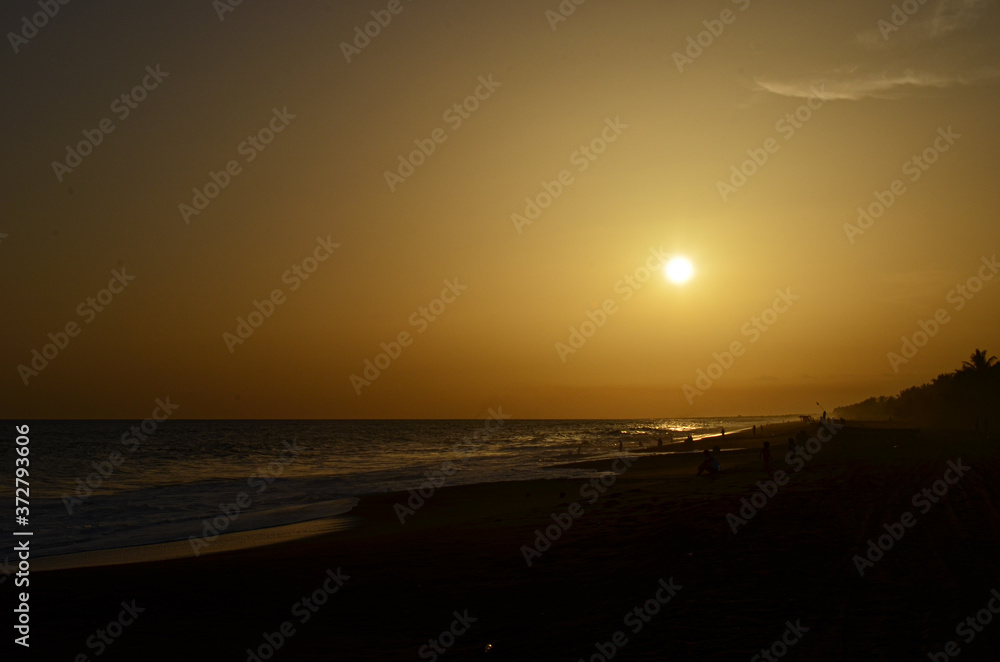 Sunset on the beach with volcanic sand in Guatemala.