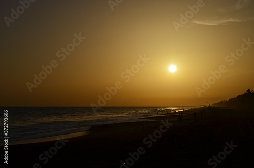 Sunset on the beach with volcanic sand in Guatemala. © Hugo