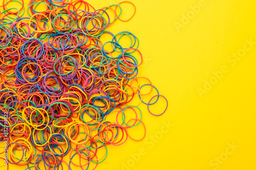 Elastic band rubber, multicolor rubber bands on yellow backgrounds