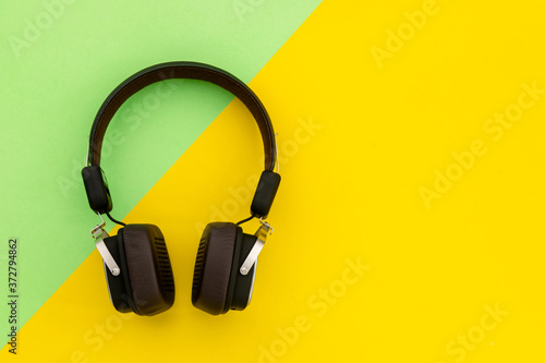 Black Headphone or Headset on bright color background. Copy space for text or design