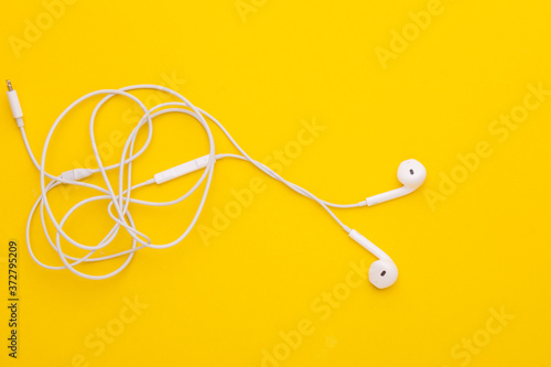 Photography White tangle earphone on yellow background