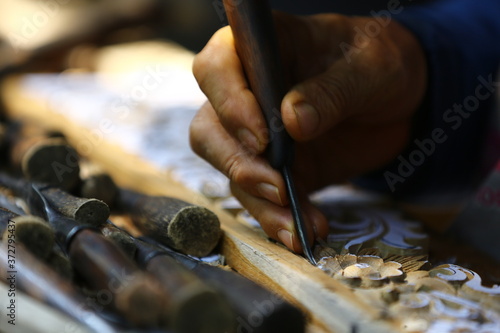 close up of a man working on a wooden