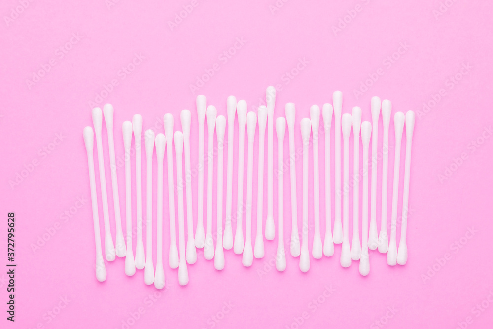Top view cotton bud for cleaning the ears on pink Top view cotton bud for cleaning the ears on pink