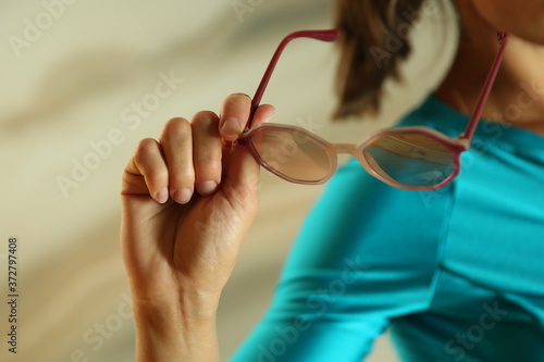  woman s hand holding sunglasses close up