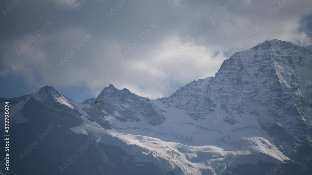 Paragliding near the beautiful snow covered Jungfrau mountains Switzerland Paragliding near the beautiful snow covered Jungfrau mountains Switzerland