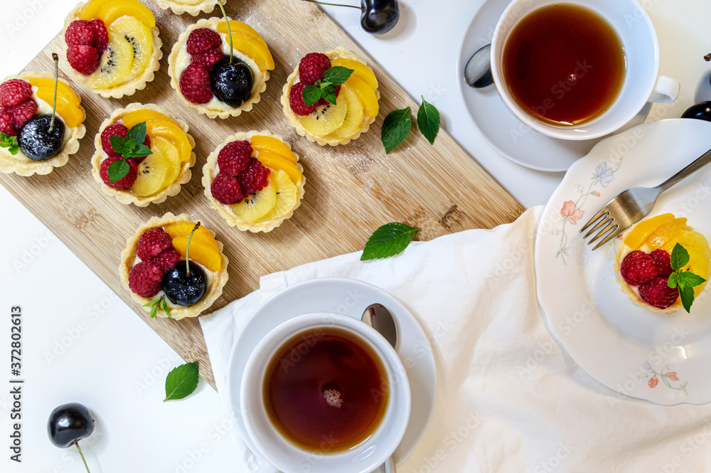 top down view of a fruit tartlet tea time scene top down view of a fruit tartlet tea time scene