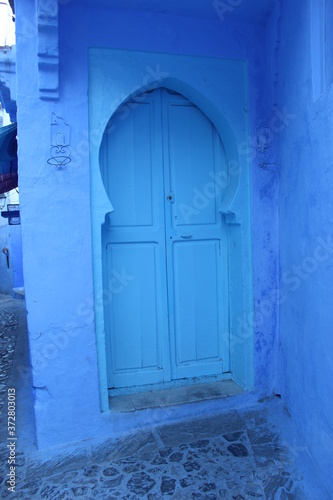 blue door in a stone wall