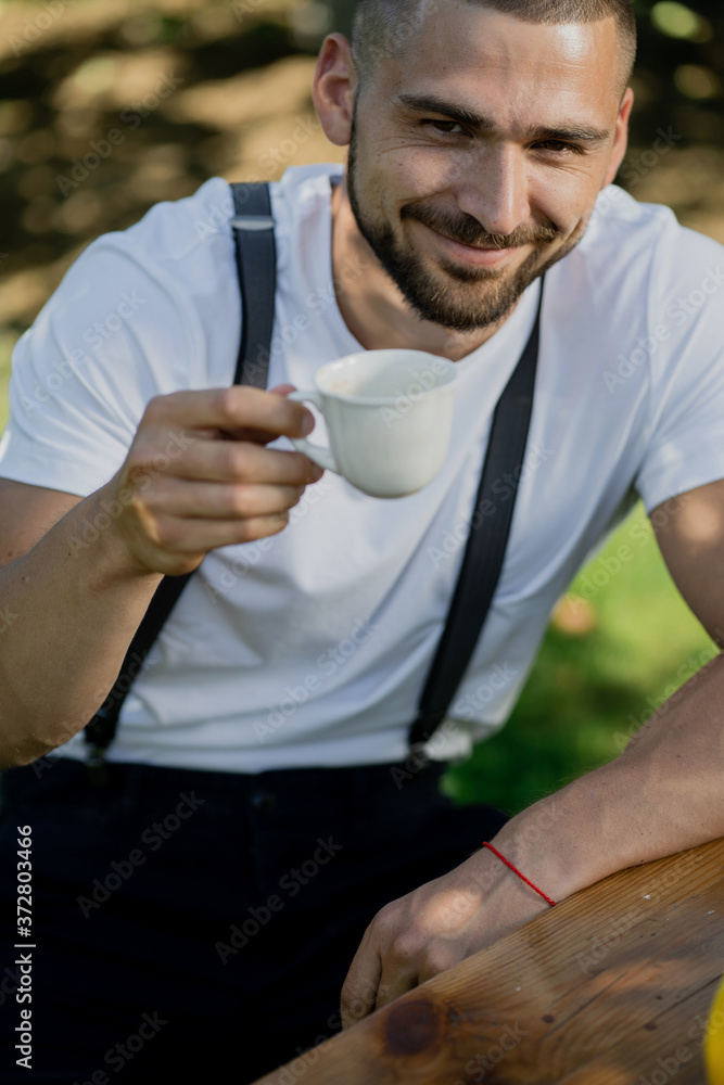 man drinking coffee in the garden man drinking coffee in the garden
