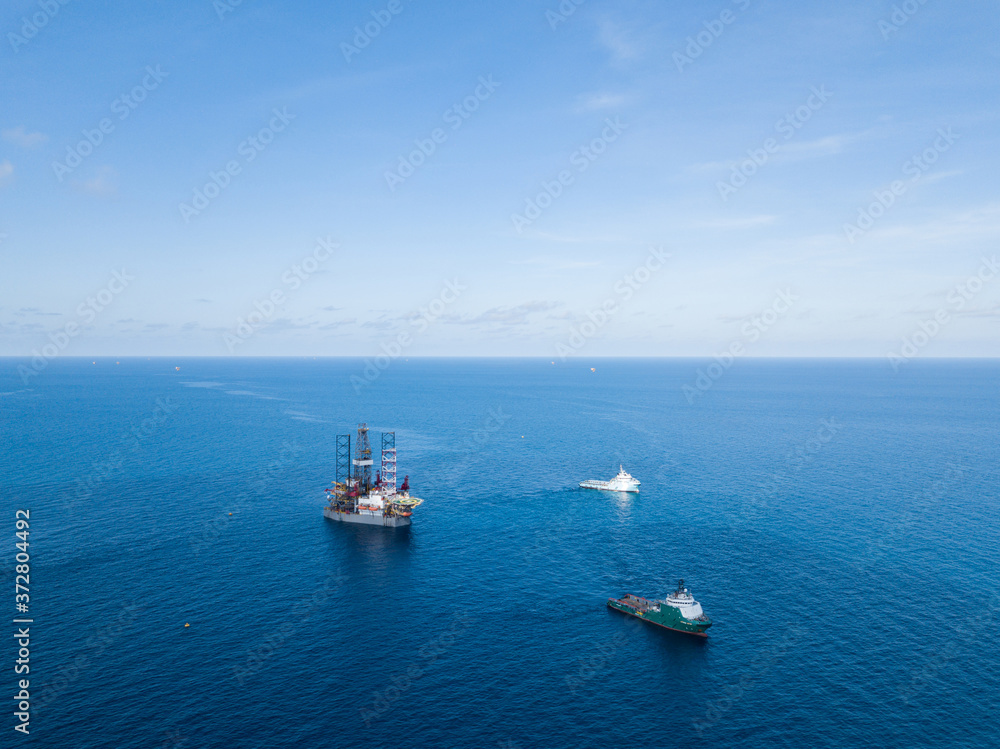 Fototapeta premium Offshore jack up rig and tow vessels during the rig move operation at the offshore location