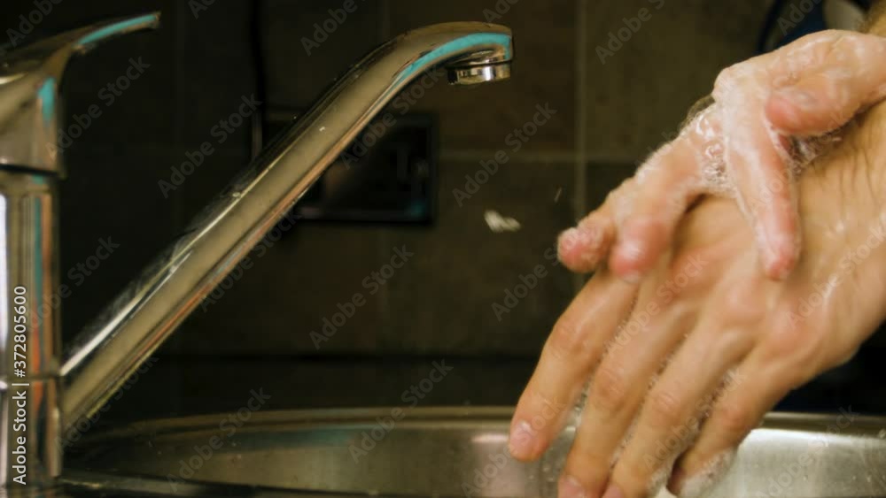 Washing hands with soap in a home kitchen sink Slow motion Washing hands with soap in a home kitchen sink Slow motion