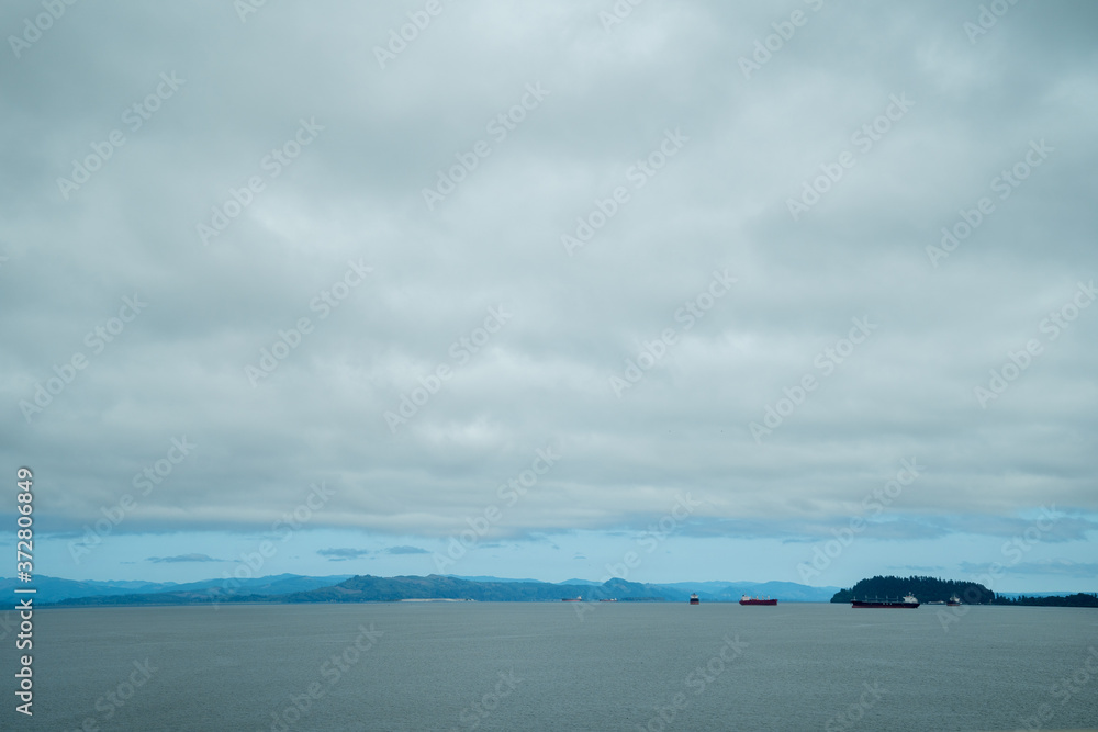 Obraz premium Expansive view of the Columbia River as seen from Astoria, Oregon, with ships and boats in the water