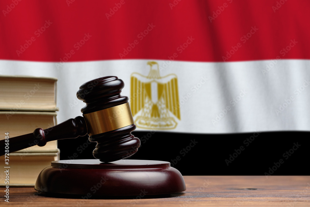 Justice and court concept in Arab Republic of Egypt. Judge hammer on a flag background