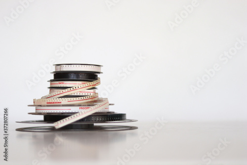 Pile of old 8mm film rolls over white background