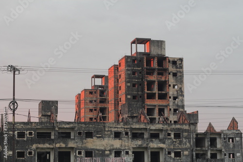 Building under construction colored by sunset