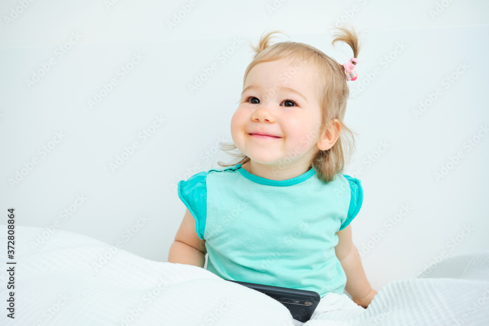 Happy toddler looks away and smiles at the house. Happy toddler looks away and smiles at the house.