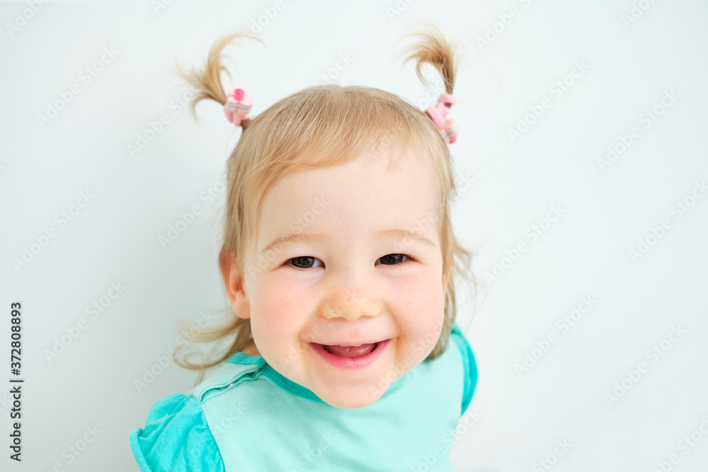 Happy kid looks at the camera and smiles at the house. Happy kid looks at the camera and smiles at the house.