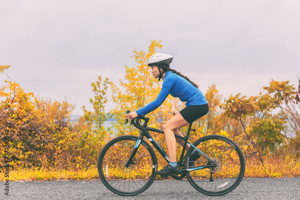 Obraz premium Bike cyclist outdoor woman biking road bicycle in autumn foliage nature.